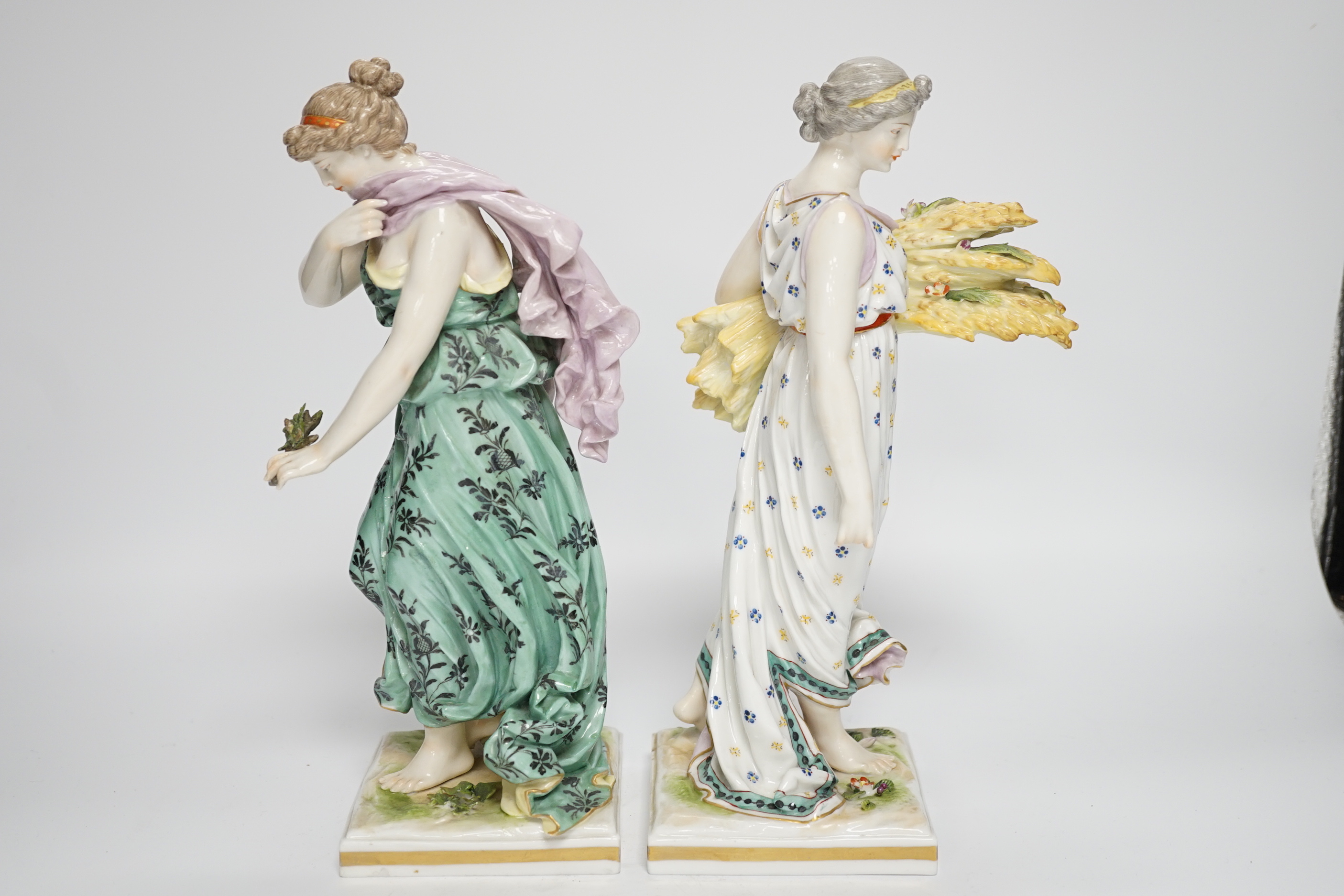 A pair of Frankenthal style porcelain female figures emblematic of summer and winter, 27.5cm